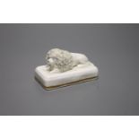 A Staffordshire porcelain poodle, recumbent on rectangular cushion base, c.1850, length