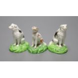 A pair of Staffordshire porcelain figures of seated dogs, height 6.5cm, and another, c.1830-