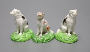 A pair of Staffordshire porcelain figures of seated dogs, height 6.5cm, and another, c.1830-