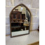 An oak lancet shaped framed wall mirror, (formerly from a dressing table) width 56cm, height 85cm