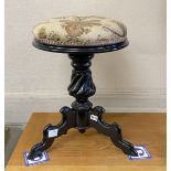 A 19th century French ebonised revolving adjustable piano stool