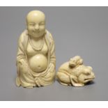 A Japanese carved ivory netsuke, in the form of a large seated toad, its infant sat upon its back,