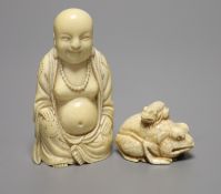 A Japanese carved ivory netsuke, in the form of a large seated toad, its infant sat upon its back,