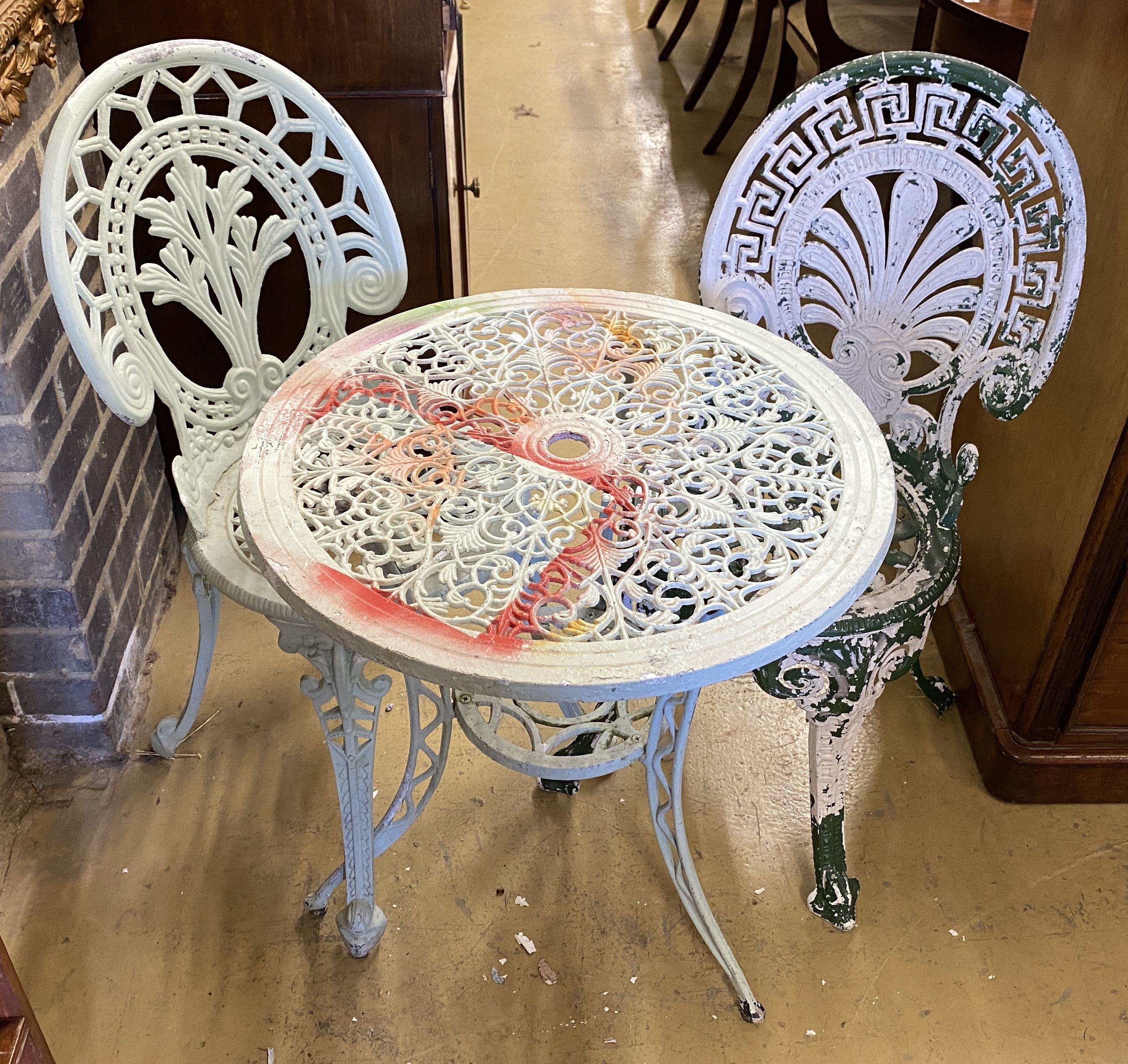 A painted aluminium circular garden table, 60cm diameter and two chairs