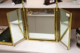 A brass framed triptych dressing mirror, height 56cm