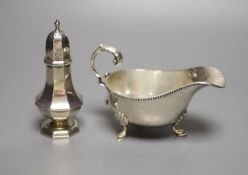 A George V silver sauceboat and an Edwardian silver pepperette, William Hutton & Sons, London, 1905,