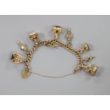 A 9ct. charm bracelet hung with nine assorted gold and gold plated seals, watch keys, etc. gross