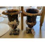 A pair of Victorian cast iron campana shaped garden urns, height 32cm