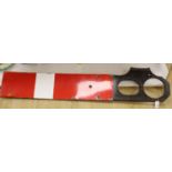 A red and white enamel railway signal