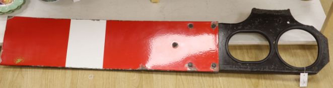 A red and white enamel railway signal