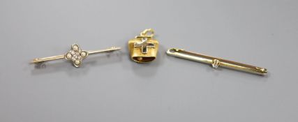 A 750 yellow metal cow bell charm, 3.6 grams a 15ct seed pearl and diamond chip set bar brooch,