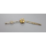 A 750 yellow metal cow bell charm, 3.6 grams a 15ct seed pearl and diamond chip set bar brooch,