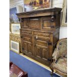 An 18th century oak court cupboard dated 1734, length 145cm, depth 55cm, height 176cm