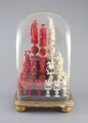 A set of 19th century Cantonese carved and red stained ivory chess pieces under dome, white king