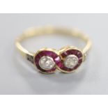 An 18ct. ruby and diamond set double target cluster ring, with diamond set shoulders, size O/P,