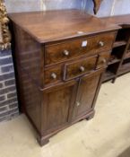 A Regency mahogany cupboard, fitted four drawers over a pair of fielded panelled doors (altered),