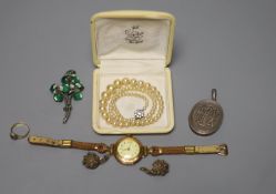 A lady's 585 yellow metal manual wind wrist watch, gross 23.2 grams, a white metal locket and
