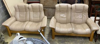 A pair of Norwegian Ekornes Stressless reclining two-seat settees with leather upholstery, length