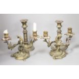 A pair of bronze rococo-style candelabra, width 25cm and a pair of telescopic candlesticks