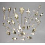 A group of assorted silver teaspoons and other mixed silver flatware, including salad serving spoon,