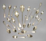 A group of assorted silver teaspoons and other mixed silver flatware, including salad serving spoon,
