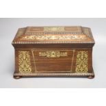 A Regency rosewood and cut brass inlaid sarcophagus shaped tea caddy, (mixing bowl restored), length