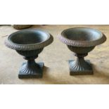 A pair of Victorian cast iron campana shaped garden urns, diameter 32cm, height 27cm