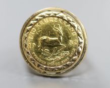 A 1980 one tenth gold Krugerrand, set in a 9ct gold ring mount, size M, gross 6.9 grams.