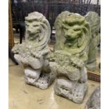 A pair of reconstituted stone lion and shield garden ornaments, height 56cm