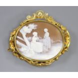 A Victorian pinchbeck mounted oval cameo shell brooch, carved with figure in a garden, 57mm.