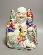 A large Chinese famille rose figure of Budai and children, mid 20th century, height 28cmCONDITION: