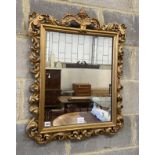 A Florentine style gilt carved wood wall mirror, width 58cm, height 76cm
