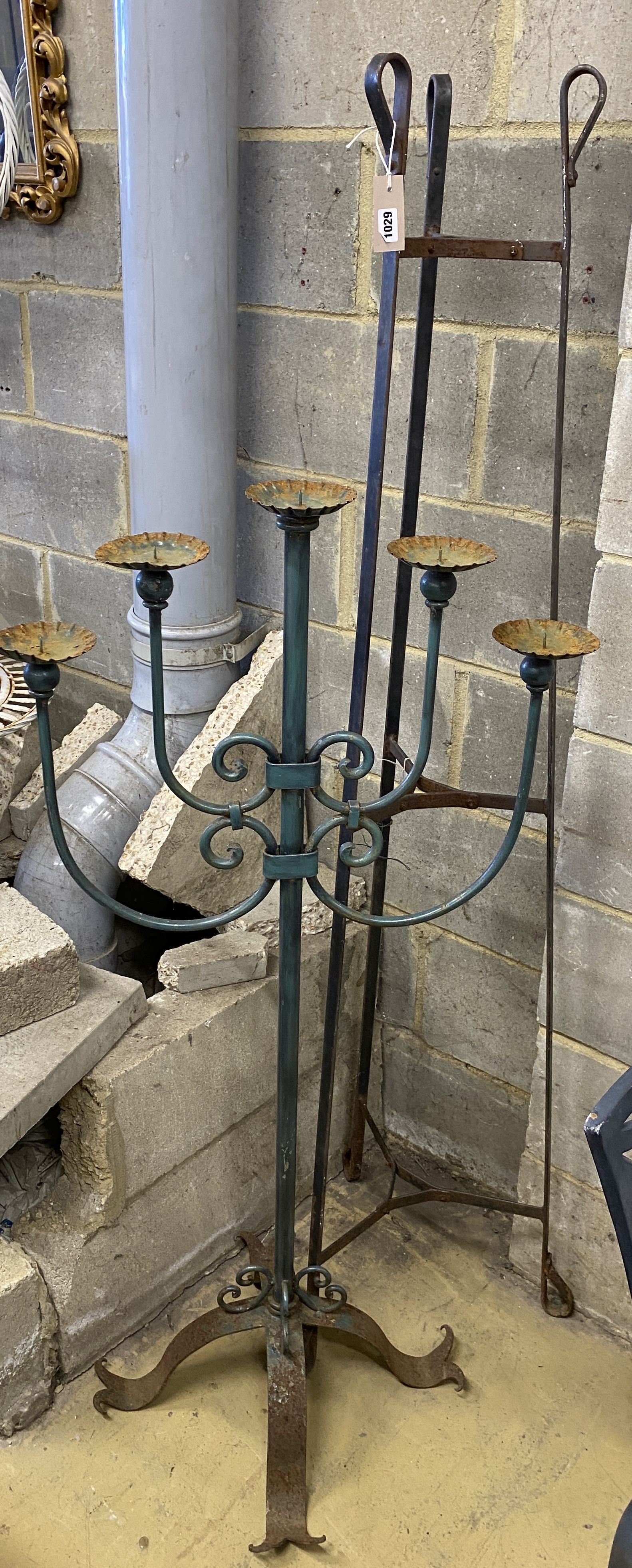 A wrought iron pot stand and large wrought iron five branch floor standing pricket candlestick,