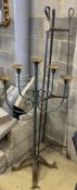 A wrought iron pot stand and large wrought iron five branch floor standing pricket candlestick,