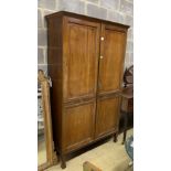 A Dutch style mahogany wardrobe, with double full length panelled doors, on square tapering legs