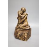 A resin sculpture of lovers on hardwood base, stamped to reverse PHD, height 34cm