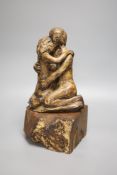 A resin sculpture of lovers on hardwood base, stamped to reverse PHD, height 34cm