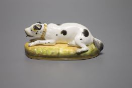 An English porcelain figure of resting dog, c.1830-50, width 13cmCONDITION: ex Dennis G. Rice