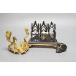 A novelty skull inkwell letter rack and a crane two branch candlestick