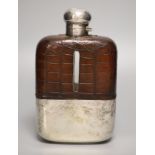 A clear cut glass and silver-plated oversized hip flask by James Dixon & Sons, crocodile jacketed,