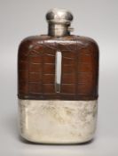 A clear cut glass and silver-plated oversized hip flask by James Dixon & Sons, crocodile jacketed,