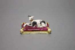 A Minton porcelain greyhound, recumbent on cushion, width 20cmCONDITION: ex Dennis G. Rice