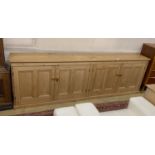 A low pine four door side cabinet, width 265cm, depth 36cm, height 83cm