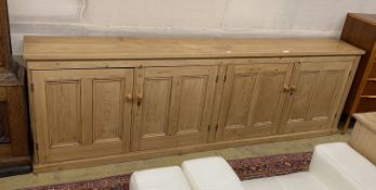 A low pine four door side cabinet, width 265cm, depth 36cm, height 83cm