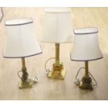 A brass Corinthian column table lamp and two others