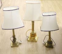 A brass Corinthian column table lamp and two others