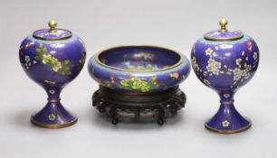 A pair of early 20th century Chinese cloisonne enamel jars and covers and a similar bowl and wood