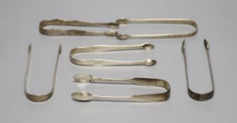 Six pairs of assorted 18th and 19th century silver sugar tongs including one bright cut engraved