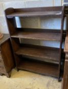 An early 20th century Wylie and Lochead style oak open bookcase, length 95cm, depth 26cm, height
