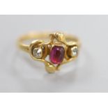 An early 20th century Arts & Crafts yellow metal, cabochon garnet and diamond set three stone